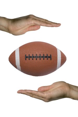 two hands holding a football (vertical)の写真素材