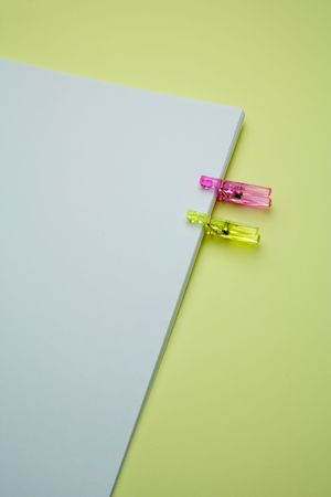 an office paper with two clothespinsの写真素材
