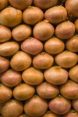 a pile of onions on the marketの写真素材