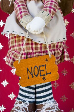 a doll with the word Noel on a boardの写真素材