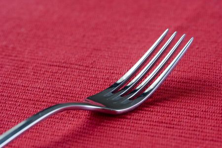 one fork in perspective over red (selective and soft focus)の写真素材