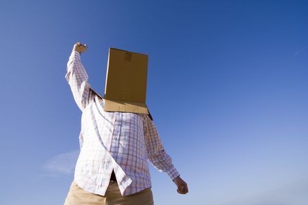 a young man with a cardboard hiding his headの写真素材