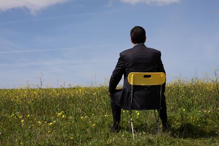 Businessman back sitting in a yellow chairの写真素材