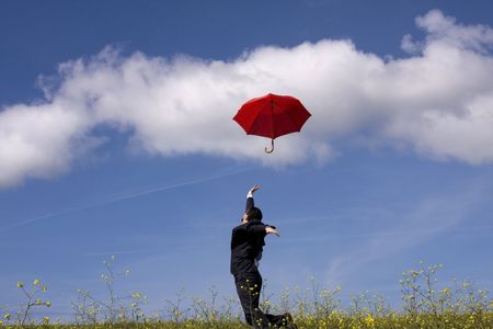 The insurance man in the field, jumping after your best protection (motion blur)の写真素材