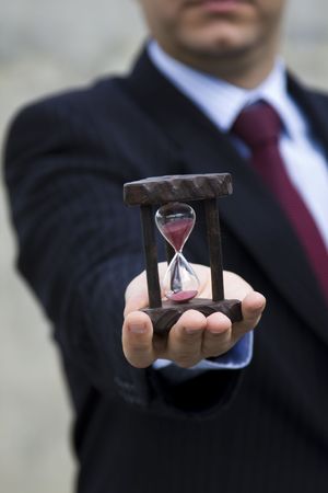 a businessman showing how to save time (selective and soft focus)