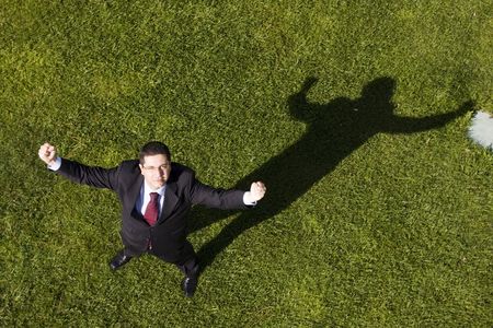 Above view of a successful businessman standing on the grass (with copy space)の写真素材