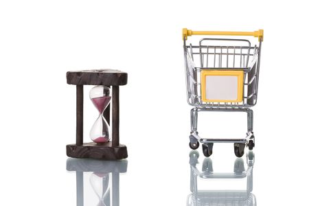 a hourglass and a shopping cart isolated with reflection
