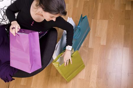 woman showing her colorful shopping bagsの写真素材