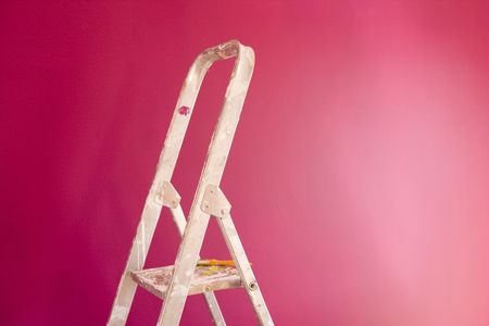 a construction ladder on a pink wallの写真素材