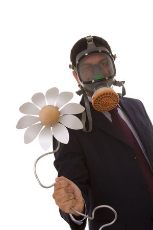 a businessman with a gas mask holding a flower from the future (selective focus)の写真素材