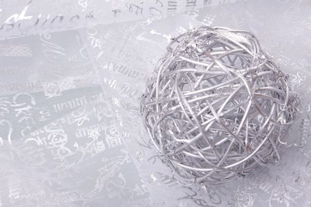 christmas ball over a seasonal tissue (selective focus)の写真素材