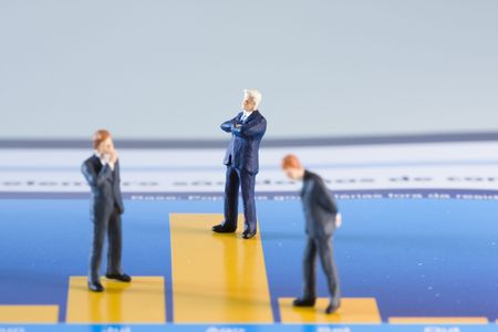 miniature businessman analysing a financial chart (selective and soft focus)の写真素材