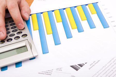 detail of a hand in a calculator controlling the business growth (selective focus)