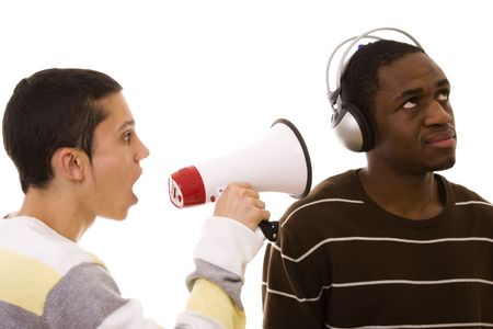 caucasian young man shouting to a african young manの写真素材