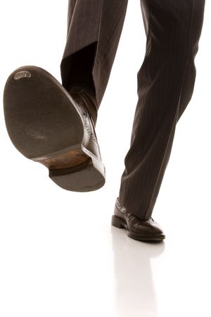 shoe and leg of a businessman caution step (selective focus) shoe and leg of a businessman caution step (selective focus)