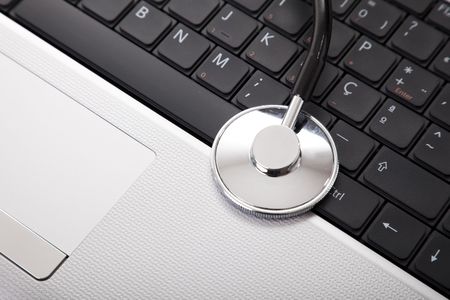 laptop with a stethoscope for good maintenance (selective focus)の写真素材