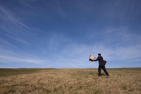 businessman with an open box at the fieldの写真素材