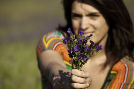 woman giving a fresh bouquet of flowers (selective focus)の写真素材