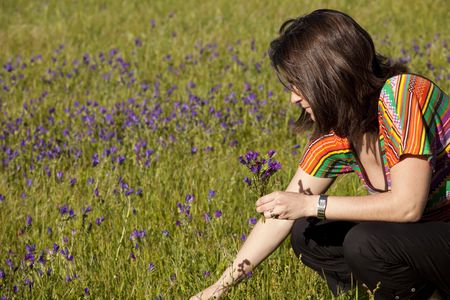 woman enjoying life in a green fieldの写真素材