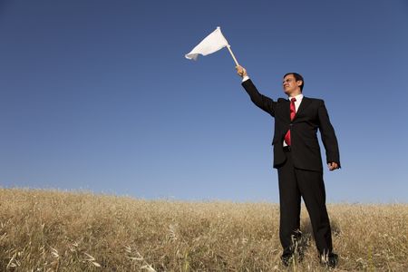 businessman asking for surrendering with a white flagの写真素材