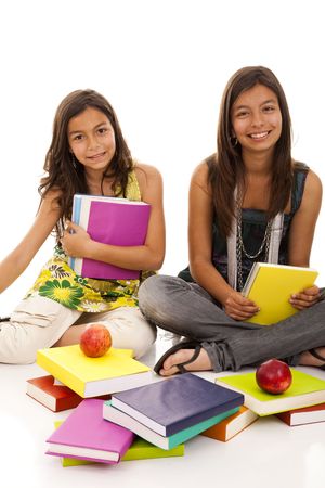 two young student sisters reading books on the floorの写真素材