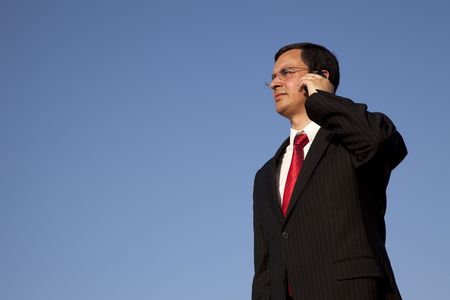 businessman talking at his cellular in the outdoorの写真素材