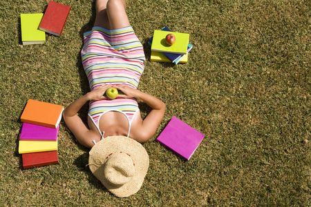 a student relaxing at the grass of the school park (the pages in the book are my self printed)の写真素材