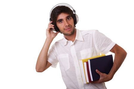 young man smiling and holding color books and listening to musicの写真素材