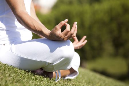 detail of a woman hands in yoga pose (selective focus)の写真素材