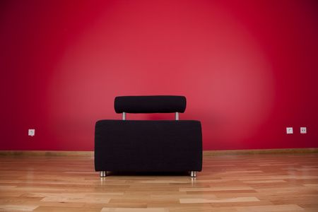 black couch in a house next to a red wallの写真素材