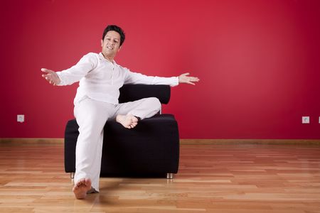 young men enjoying his new house in the couchの写真素材