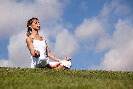 young woman enjoying nature in a yoga poseの写真素材