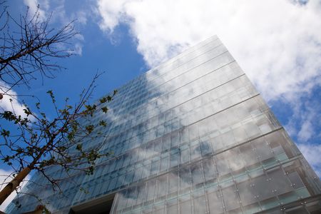 detail of a modern office building with sky reflectionの写真素材