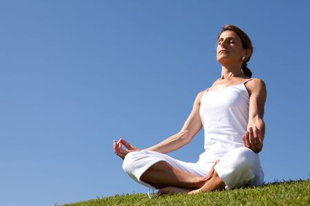 young woman enjoying nature in a yoga poseの写真素材
