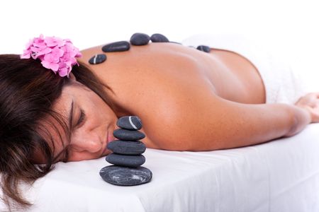 young beautiful woman in a spa enjoying a hot stone treatmentの写真素材