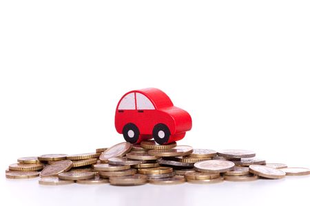 red car over a lot of golden coins (isolated on white)の写真素材