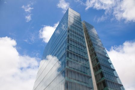 detail of a modern office building with sky reflectionの写真素材