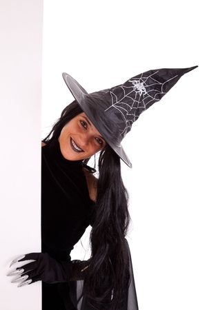 halloween witch holding a blank banner (isolated on white)の写真素材