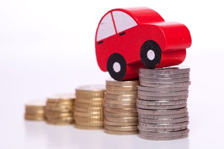 red car over a lot of stacked coins の写真素材