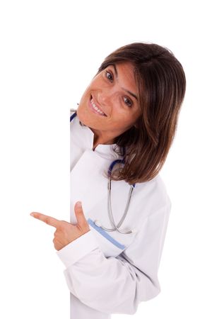 friendly woman doctor pointing to the copy space in a banner (isolated on white)の写真素材