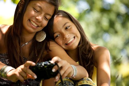 two young sisters taking a picture of themselves (selective focus)の写真素材