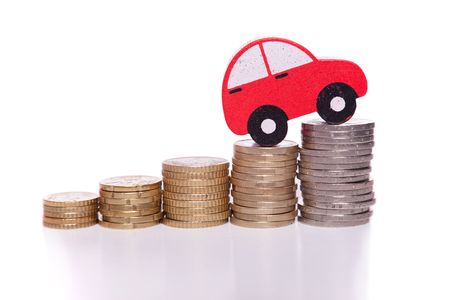 red car over a lot of stacked coins の写真素材