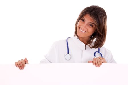 friendly woman doctor pointing to the copy space in a banner (isolated on white)の写真素材