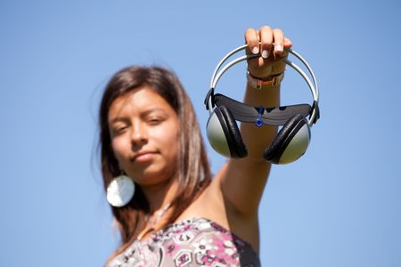 young teenager showing her headphones (selective focus)の写真素材