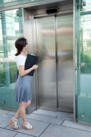 modern businesswoman waiting for the elevatorの写真素材