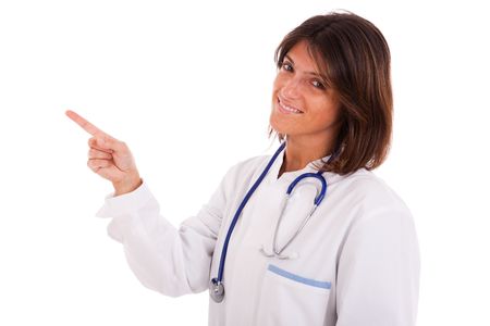 friendly woman doctor pointing to the copyspace (isolated on white)の写真素材