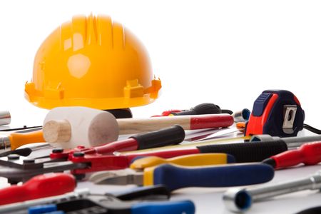 a mix of construction tools over a white background