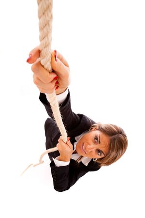 businesswoman climbing up a rope (isolated on white)の写真素材