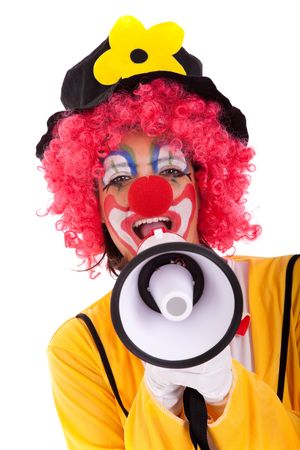 loud funny message from a clown with a megaphone (isolated on whites)の写真素材