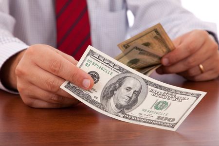 businessman at the office giving moneyの写真素材